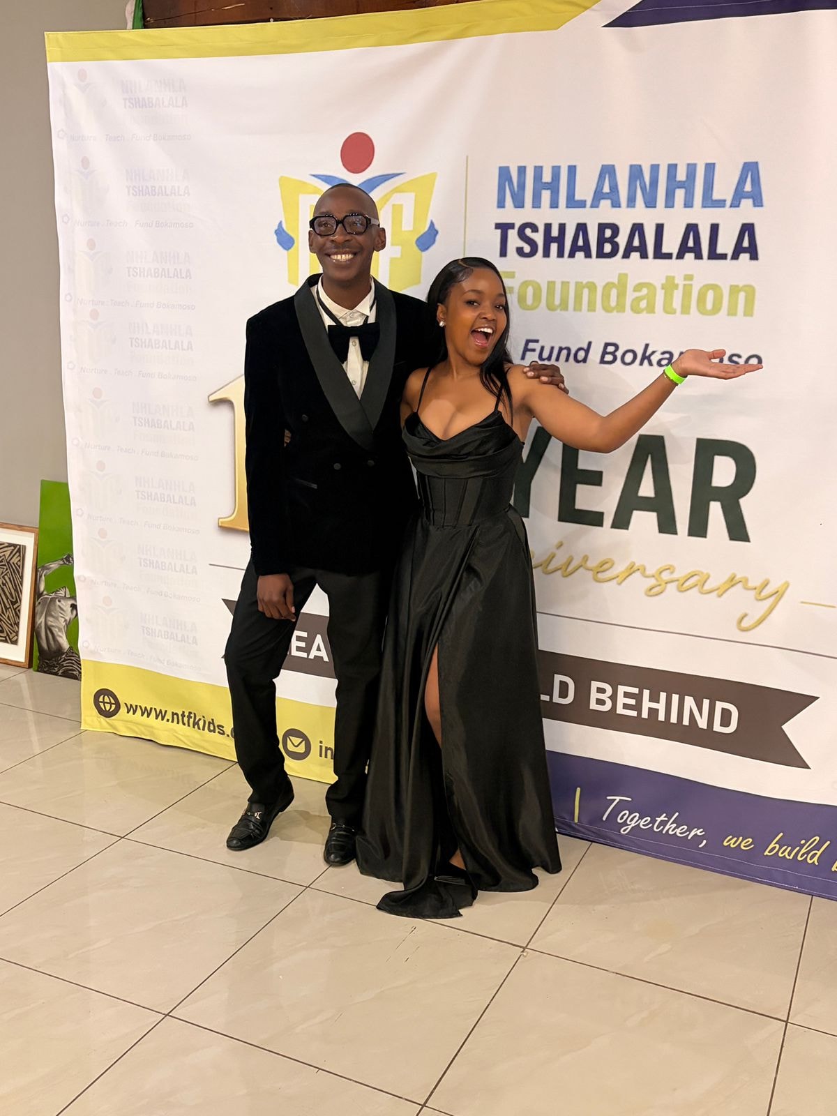 Well-dressed pair posing at a charity event